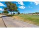 Scenic view of a lush golf course with mature trees lining the green, near walking path at 15133 W Wildfire Dr, Surprise, AZ 85374