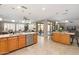 Bright, open kitchen with granite countertops, a stainless steel dishwasher, and an open view to the living area at 15133 W Wildfire Dr, Surprise, AZ 85374