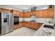 Kitchen with stainless steel appliances, custom wood cabinetry, and granite countertops at 15133 W Wildfire Dr, Surprise, AZ 85374