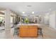Kitchen island with barstool seating, overlooking the living space and sliding glass doors at 15133 W Wildfire Dr, Surprise, AZ 85374