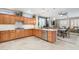 Well-lit kitchen featuring wooden cabinets, stainless steel appliances, marble countertops, and an open layout at 15133 W Wildfire Dr, Surprise, AZ 85374