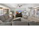 Comfortable living room featuring a plush sectional sofa, stylish accent chair, and large TV at 15133 W Wildfire Dr, Surprise, AZ 85374