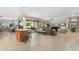 Open-concept living area featuring a kitchen island, large sofa, and sliding glass doors to patio at 15133 W Wildfire Dr, Surprise, AZ 85374