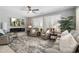 Comfortable living room features plantation shutters, electric fireplace, and soft, neutral decor at 15133 W Wildfire Dr, Surprise, AZ 85374