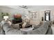 Spacious living room with a large sectional sofa, ceiling fan, and modern decor at 15133 W Wildfire Dr, Surprise, AZ 85374