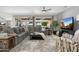 Expansive living room showcasing a sectional sofa, ceiling fan, and sliding glass doors at 15133 W Wildfire Dr, Surprise, AZ 85374