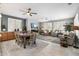 Open concept living and dining area with fireplace, plantation shutters and comfortable seating at 15133 W Wildfire Dr, Surprise, AZ 85374