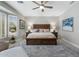 Bright main bedroom showcasing a bay window, neutral decor, a wooden bed frame, and wall art at 15133 W Wildfire Dr, Surprise, AZ 85374