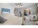 Relaxing main bedroom featuring a sliding glass door, an ensuite outdoor seating area, and neutral decor at 15133 W Wildfire Dr, Surprise, AZ 85374