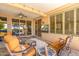 Covered outdoor patio with a ceiling fan, outdoor seating, and a mounted television at 15133 W Wildfire Dr, Surprise, AZ 85374