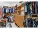 Large walk-in closet with built-in shelves, drawers, and hanging rods at 15133 W Wildfire Dr, Surprise, AZ 85374