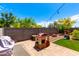 Inviting backyard featuring patio area, play structure, and mature trees for outdoor living at 15423 N 22Nd Dr, Phoenix, AZ 85023