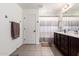 Functional bathroom offers tile floors, vanity, and shower with curtain, as well as towel racks at 15423 N 22Nd Dr, Phoenix, AZ 85023