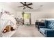 Bright, carpeted bedroom includes a play tent, ceiling fan, sitting area, and window view at 15423 N 22Nd Dr, Phoenix, AZ 85023