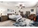 Inviting primary bedroom featuring a ceiling fan, soft lighting, and a cozy seating area at 15423 N 22Nd Dr, Phoenix, AZ 85023