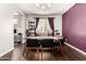 Dining room with a dining table and chairs in front of a window and with a purple accent wall at 15423 N 22Nd Dr, Phoenix, AZ 85023
