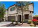 Beautiful two-story home featuring a stucco exterior, brown shutters, and well-maintained desert landscaping at 15423 N 22Nd Dr, Phoenix, AZ 85023
