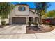 Charming two-story home featuring a stucco facade, brown accents, and a well-manicured front yard at 15423 N 22Nd Dr, Phoenix, AZ 85023