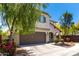 Inviting stucco two-story home featuring a two-car garage, desert landscaping, and a well-kept front yard at 15423 N 22Nd Dr, Phoenix, AZ 85023