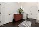 Bright foyer featuring dark wood floors, white walls, high ceilings, and decorative accent furniture at 15423 N 22Nd Dr, Phoenix, AZ 85023
