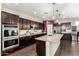 Gourmet kitchen with a large island, stainless appliances, and dark wood cabinetry perfect for the home chef at 15423 N 22Nd Dr, Phoenix, AZ 85023