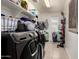 Functional laundry room equipped with modern washer and dryer, ample storage, and convenient organization at 15423 N 22Nd Dr, Phoenix, AZ 85023