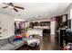Open concept living area features kitchen with stainless appliances and dark wood cabinets and an adjacent living room at 15423 N 22Nd Dr, Phoenix, AZ 85023