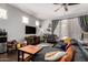 Cozy living room featuring a sectional sofa, ceiling fan, and windows with soft lighting at 15423 N 22Nd Dr, Phoenix, AZ 85023