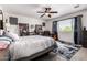 Spacious main bedroom features a ceiling fan, bookshelves, large window, and stylish rug at 15423 N 22Nd Dr, Phoenix, AZ 85023