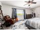 Relaxing main bedroom with a comfortable chair, guitar, and natural light from the window at 15423 N 22Nd Dr, Phoenix, AZ 85023