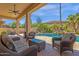 Covered patio overlooking a sparkling pool and beautifully landscaped backyard at 15608 E Chaparral Way, Fountain Hills, AZ 85268