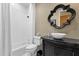 This bathroom features a sleek black vanity, bowl sink, and subway tiled shower/tub combo at 15608 E Chaparral Way, Fountain Hills, AZ 85268
