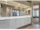 Bright bathroom featuring dual sinks, white cabinetry, and a view to the bedroom and shower at 15608 E Chaparral Way, Fountain Hills, AZ 85268