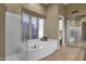 Bathroom featuring a large soaking tub, a glass shower and a vanity with mirrors at 15608 E Chaparral Way, Fountain Hills, AZ 85268