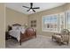 Cozy bedroom with a comfortable bed, a ceiling fan, and a view of the home exterior at 15608 E Chaparral Way, Fountain Hills, AZ 85268