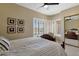 Bright bedroom featuring a window nook, ceiling fan, and mirrored closet at 15608 E Chaparral Way, Fountain Hills, AZ 85268