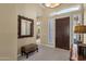 Well-lit foyer featuring tile floors, a mirror, and a decorative wood front door at 15608 E Chaparral Way, Fountain Hills, AZ 85268