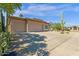 Tan home featuring a driveway and desert landscaping including a tall cactus in the front yard at 15608 E Chaparral Way, Fountain Hills, AZ 85268