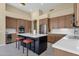 Kitchen with an island, seating, wine cooler, and stainless steel appliances at 15608 E Chaparral Way, Fountain Hills, AZ 85268