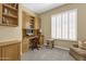 This well-lit home office features built in storage, a desk, and a large window at 15608 E Chaparral Way, Fountain Hills, AZ 85268