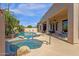 Backyard spa and pool surrounded by desert landscaping and a covered patio at 15608 E Chaparral Way, Fountain Hills, AZ 85268