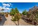Lush backyard featuring desert landscaping and a patio, perfect for relaxing and enjoying the outdoors at 15691 W Arbor Trl, Surprise, AZ 85374