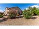 Charming backyard featuring desert landscaping, with a patio area perfect for outdoor relaxation at 15691 W Arbor Trl, Surprise, AZ 85374