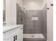 Modern bathroom featuring a glass-enclosed shower with gray tiling and sleek fixtures at 15691 W Arbor Trl, Surprise, AZ 85374