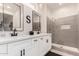 Modern bathroom with dual sinks, quartz countertops, and glass-enclosed shower at 15691 W Arbor Trl, Surprise, AZ 85374