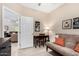 Bedroom with a futon, desk, and doorway to another room at 15691 W Arbor Trl, Surprise, AZ 85374