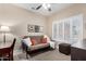 Bedroom with a futon, ceiling fan, and plantation shutters at 15691 W Arbor Trl, Surprise, AZ 85374