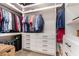 Walk-in closet with custom shelving, drawers, and ample hanging space for organized storage at 15691 W Arbor Trl, Surprise, AZ 85374