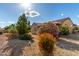 Inviting home exterior featuring desert landscaping and a covered patio, blending low-maintenance style with charm at 15691 W Arbor Trl, Surprise, AZ 85374