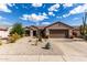 Charming single-story home showcasing desert landscaping, a tile roof and two-car garage at 15691 W Arbor Trl, Surprise, AZ 85374
